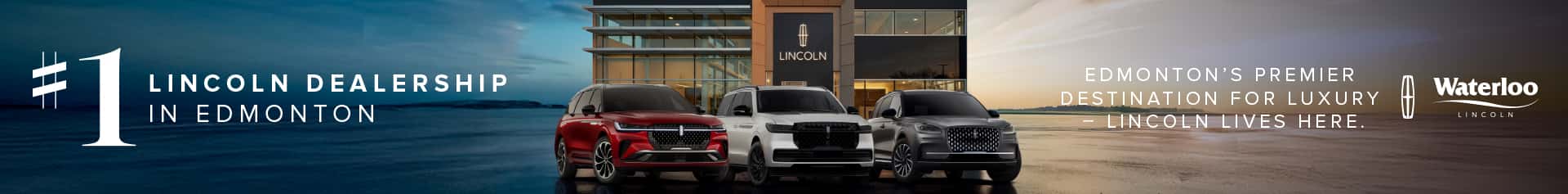 Exterior view of Waterloo Lincoln dealership at sunset with three luxury Lincoln SUVs parked in front. Text reads: 