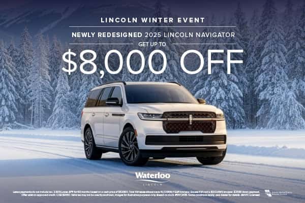 A white 2025 Lincoln Navigator parked on a snowy road surrounded by a dense forest of snow-covered trees.