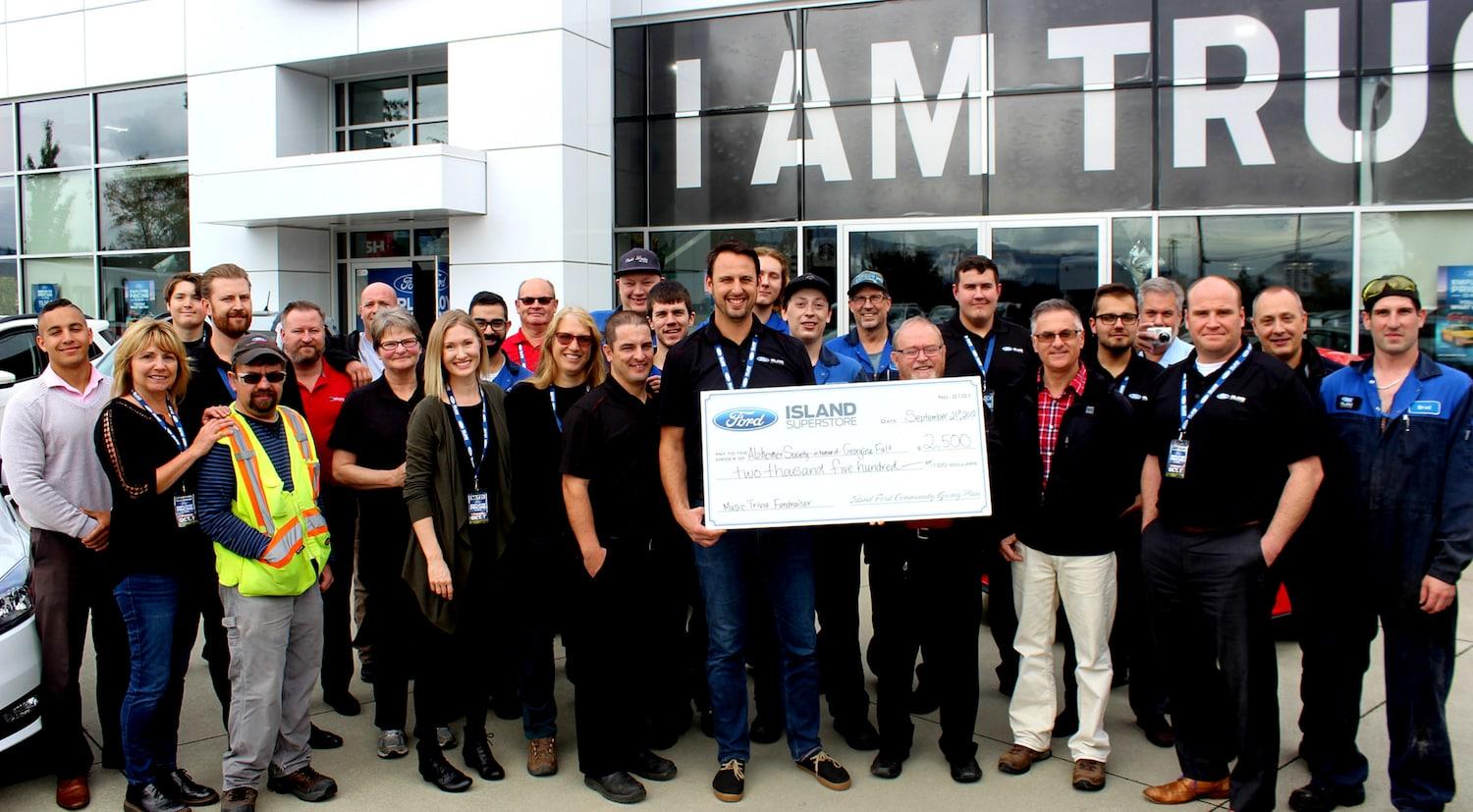 Island Ford donating to the Alzheimer's society Georgina Fault Music Trivia fundraiser