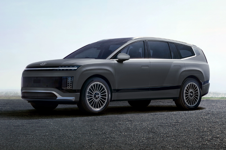 Blue 2026 Hyundai IONIQ 9 parked on a beach, emphasizing its bold presence and elegant proportions