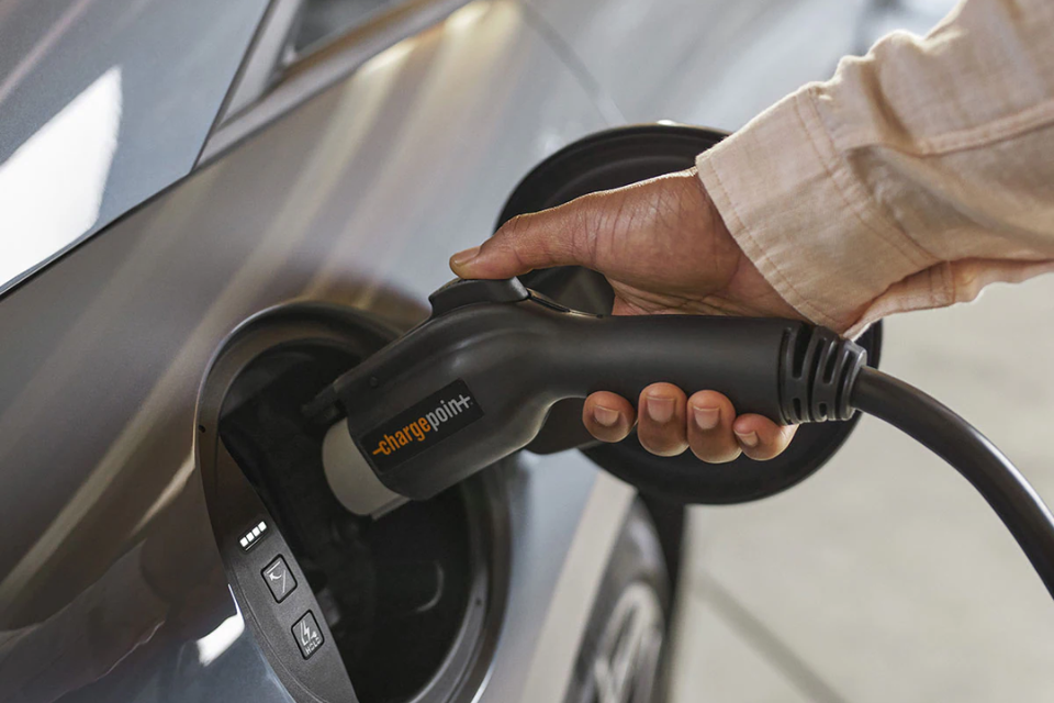 Close-up of a person plugging a ChargePoint connector into the 2025 Hyundai IONIQ 6 charging port