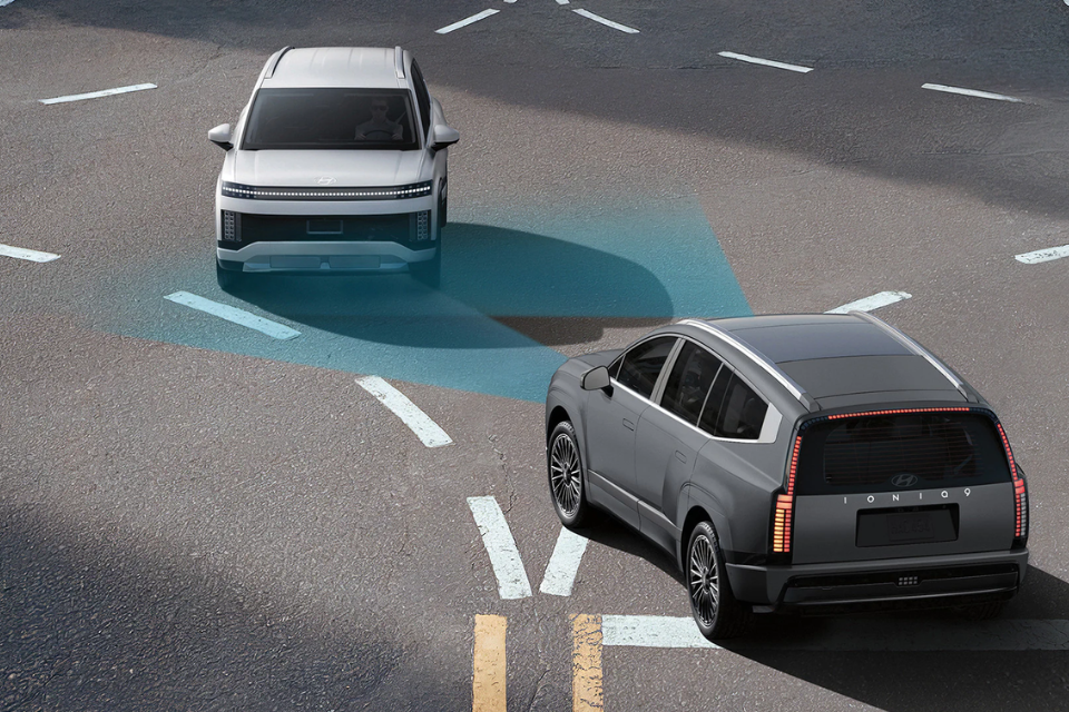Top-down view of two 2026 Hyundai IONIQ 9 SUVs at an intersection demonstrating advanced driver-assistance technology