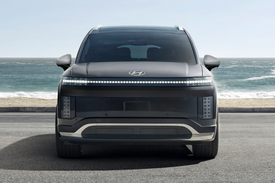 “Front view of the 2026 Hyundai IONIQ 9 electric SUV parked by the ocean, showcasing its pixel-inspired LED lighting design