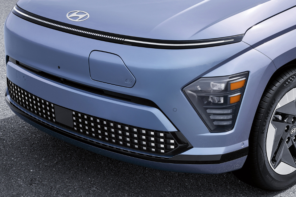 Close-up of the Hyundai Kona Electric front fascia with smooth grille design and distinctive lighting elements.
