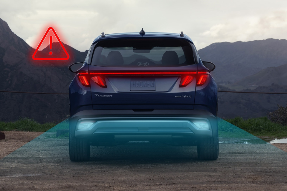 Rear view of the 2026 Hyundai Tucson Hybrid highlighting LED taillights and advanced safety alert system.
