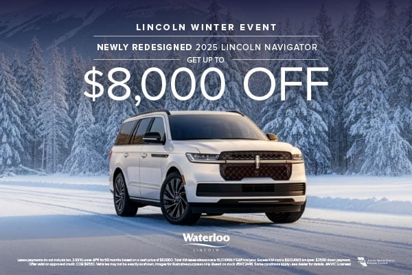 A white 2025 Lincoln Navigator parked on a snowy road surrounded by a dense forest of snow-covered trees.
