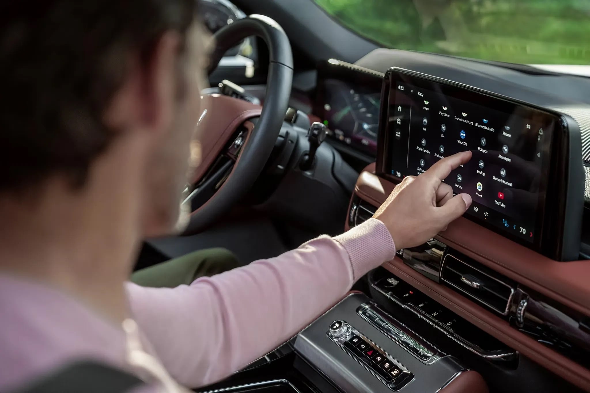 2026 Lincoln Aviator driver adjusting infotainment controls on luxury dashboard