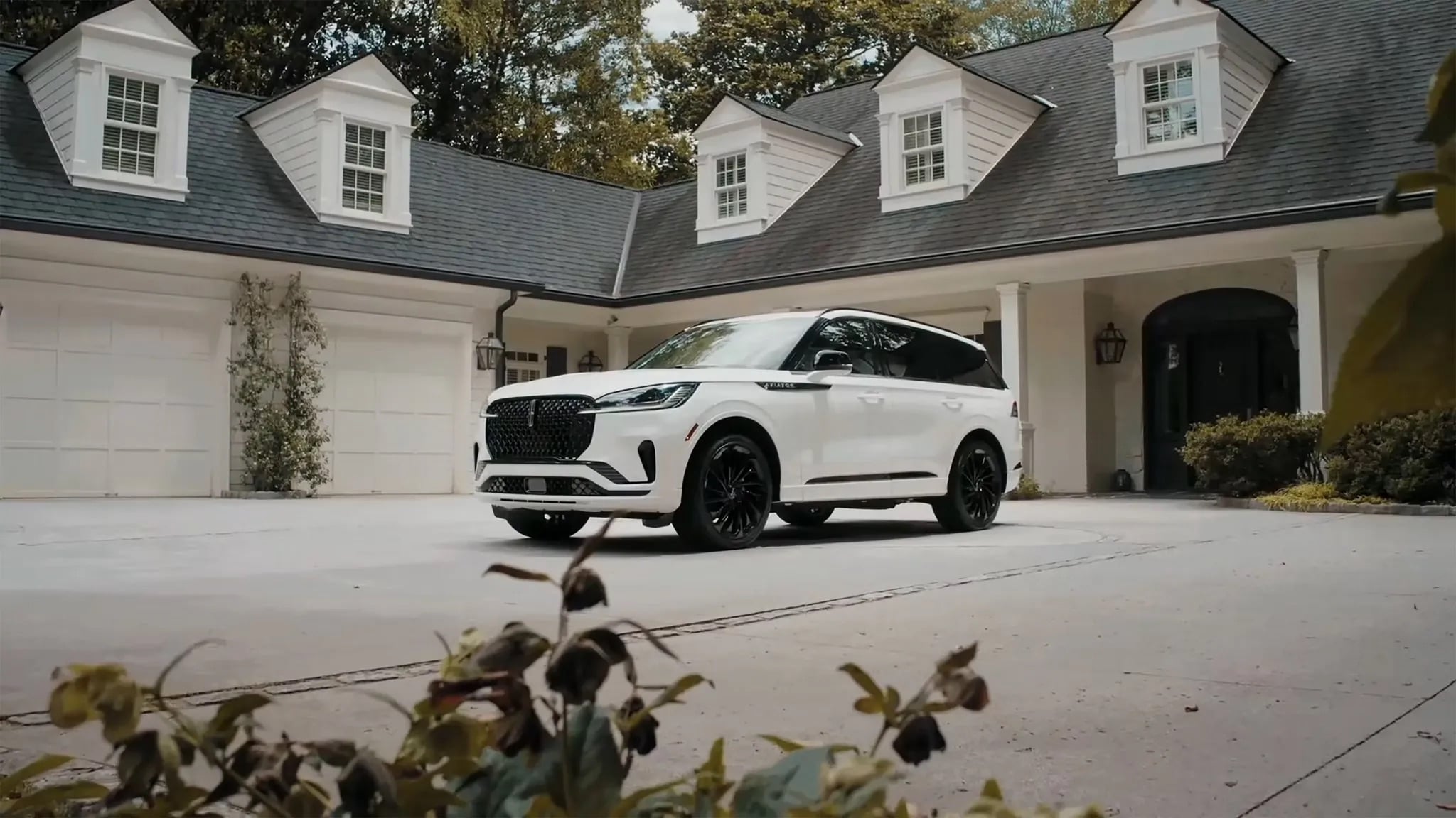 2026 Lincoln Aviator white luxury SUV parked at upscale residential home driveway