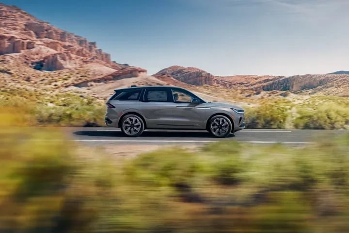 2026 Lincoln Nautilus luxury SUV driving through scenic mountain road landscape