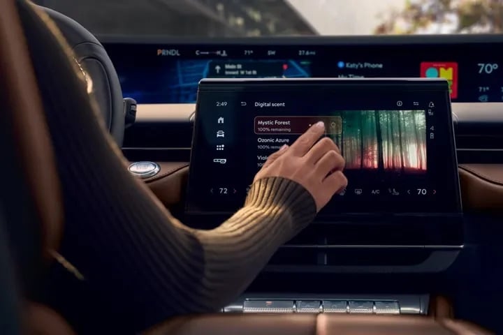 2026 Lincoln Nautilus driver interacting with large panoramic touchscreen infotainment display