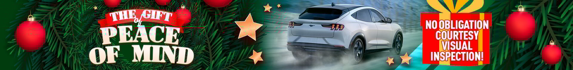 A winter holiday-themed graphic featuring a white Ford Mustang Mach-E driving on a snowy road. Festive ornaments, stars, and greenery surround the scene. A wreath displays the text “The Gift of Peace of Mind,” and a bright gift box promotes a “No obligation courtesy visual inspection.”