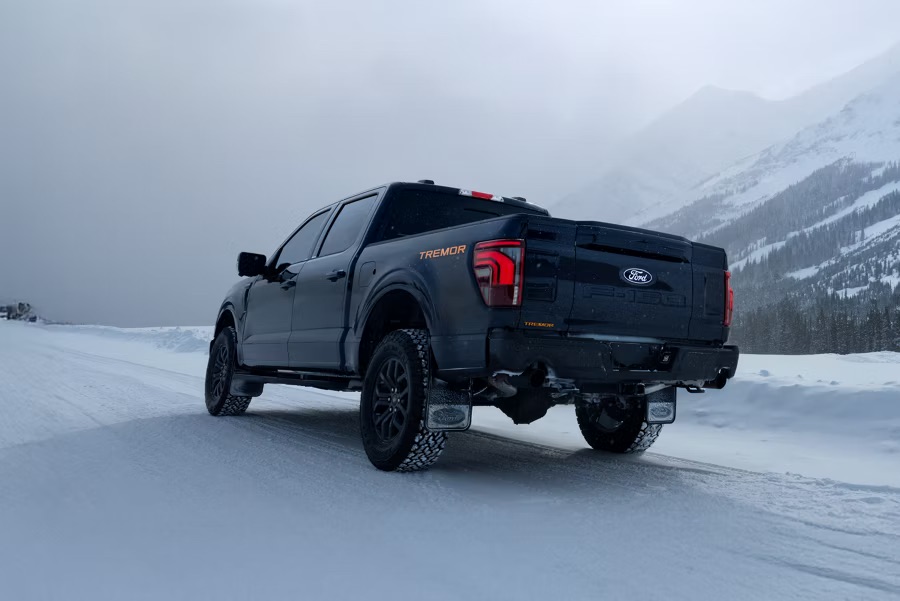 Ford F-150 Tremor on snowy Alberta highway, highlighting Freedom Ford’s Edmonton year-end truck deals during December clearance.