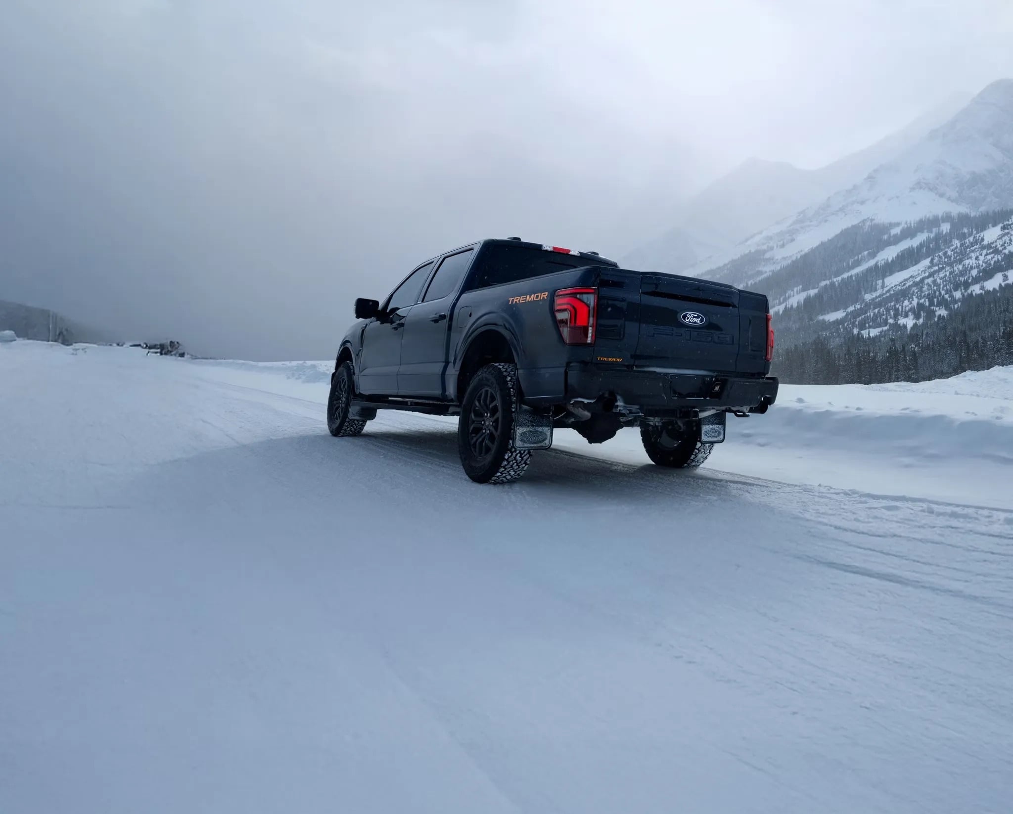 2026 Ford F-150 driving through snowy mountain terrain