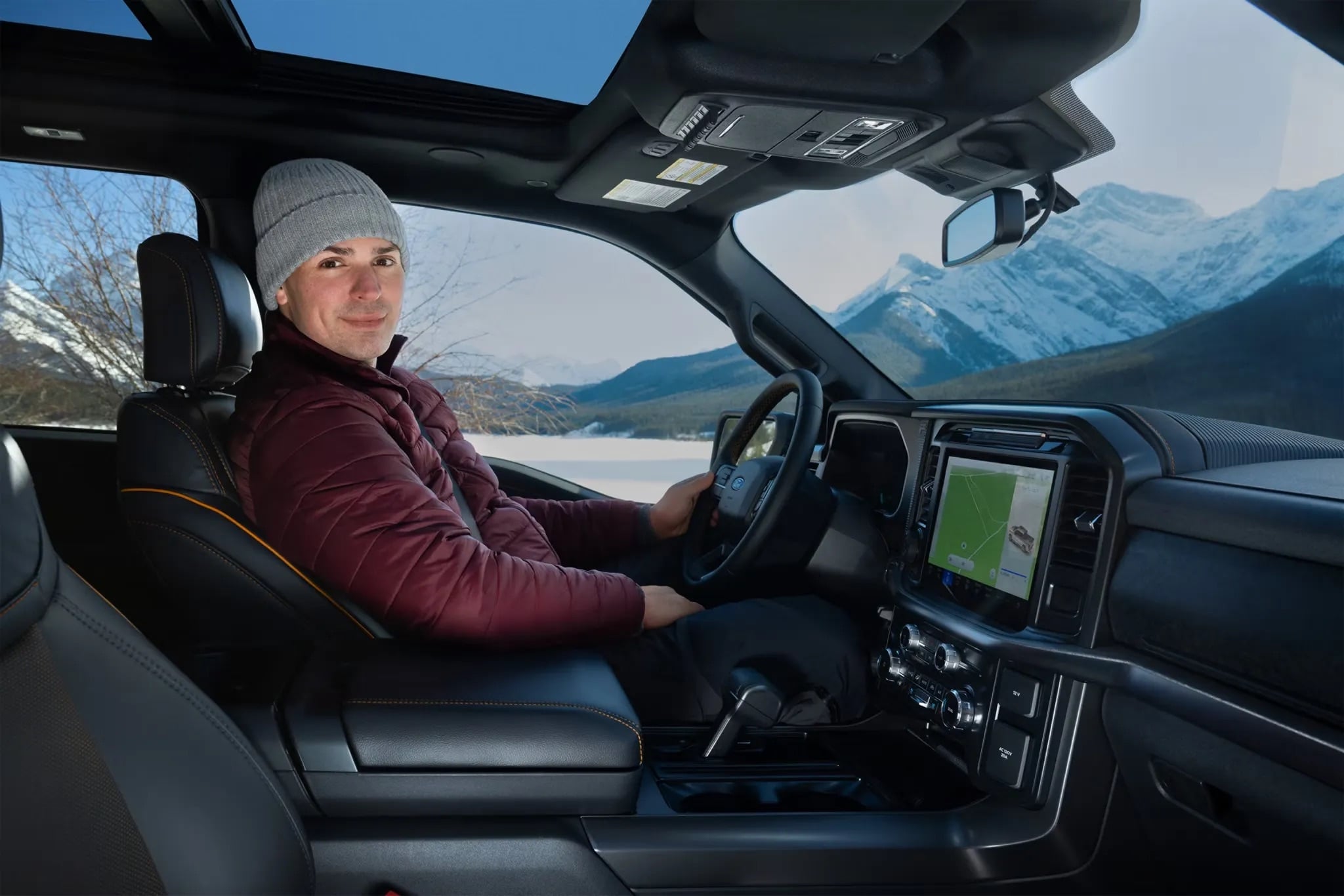 Driver seated inside the 2026 Ford F-150 viewing the dashboard display