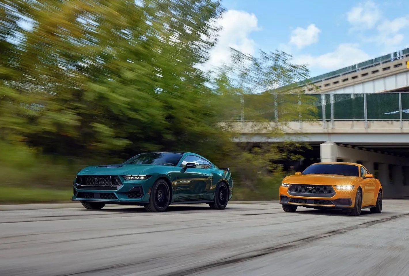 2026 Ford Mustang in Adriatic Blue Metallic and Orange Fury Metallic Tri-coat, showcasing aggressive front grille, sleek body lines, and sporty rear design.