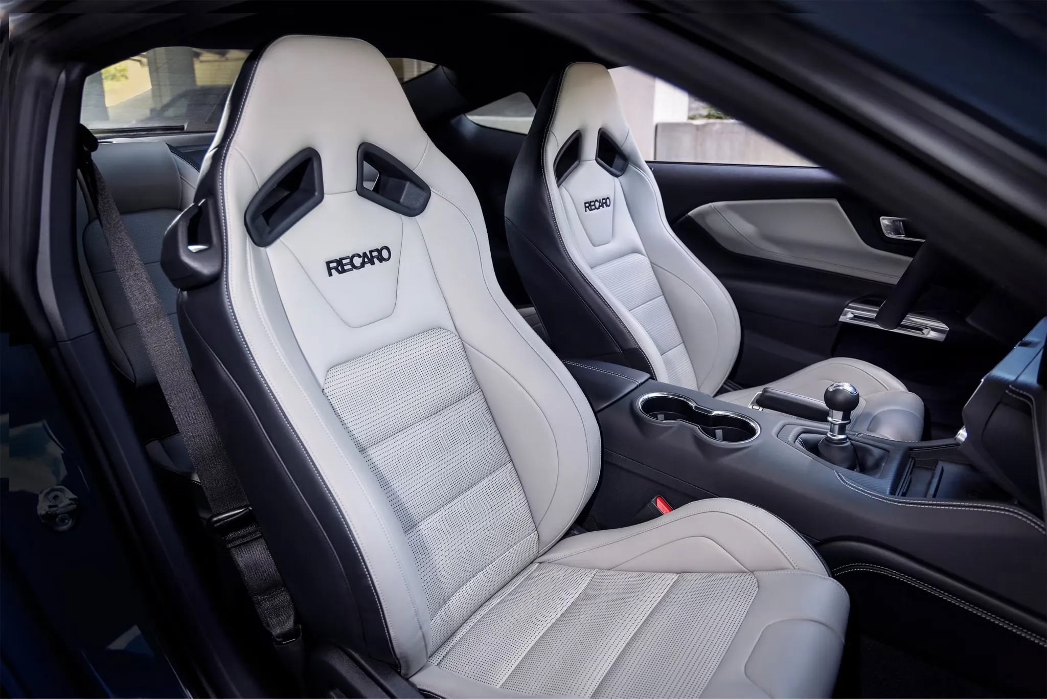2026 Ford Mustang with optional white RECARO® Sport Seats, highlighting premium leather upholstery, bolstered support, and performance-focused interior design