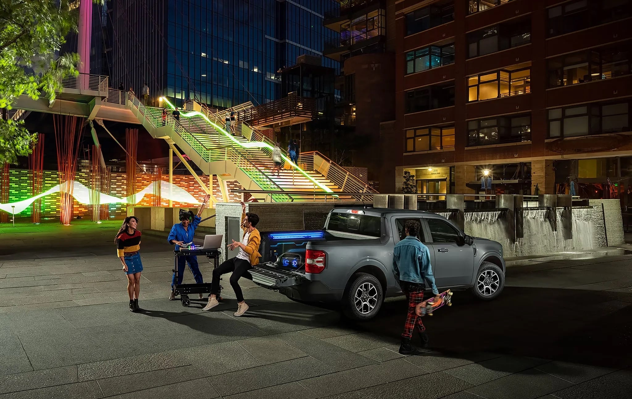 2026 Ford Maverick parked in city at night with tailgate open lifestyle scene