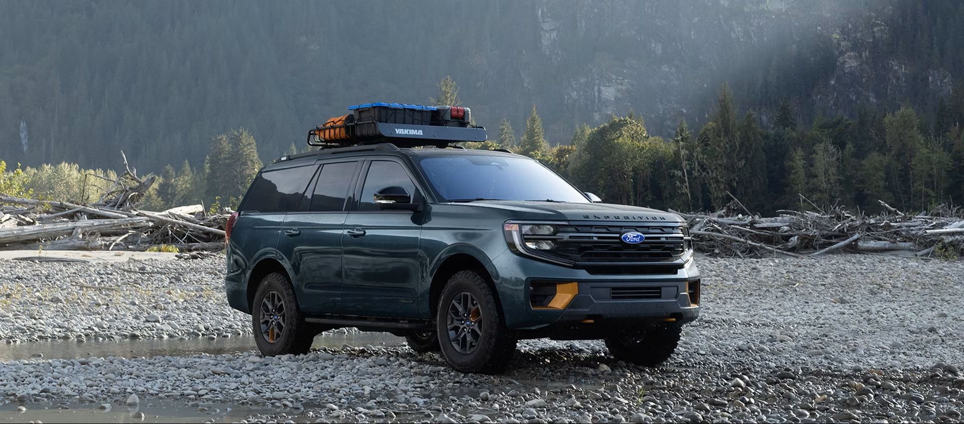 2027 Ford Expedition parked near a lake with mountain scenery in the background