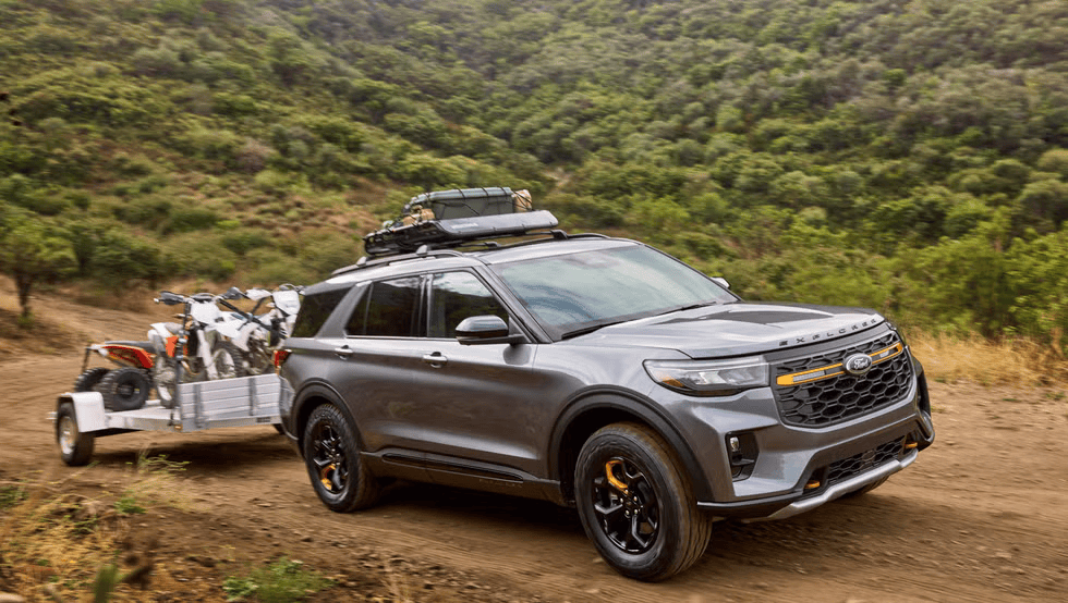 The 2026 Ford Explorer Tremor from Waterloo Ford towing two motorcycles on a rugged trail, highlighting its capability and adventurous design.