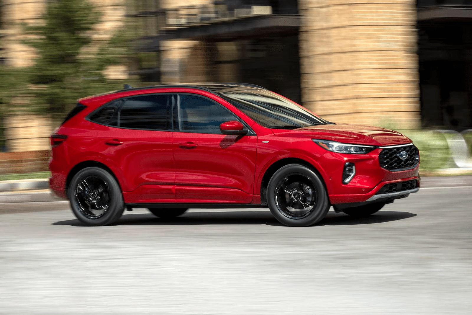 Red Ford Escape ST-Line driving through the city, shown by Waterloo Ford.