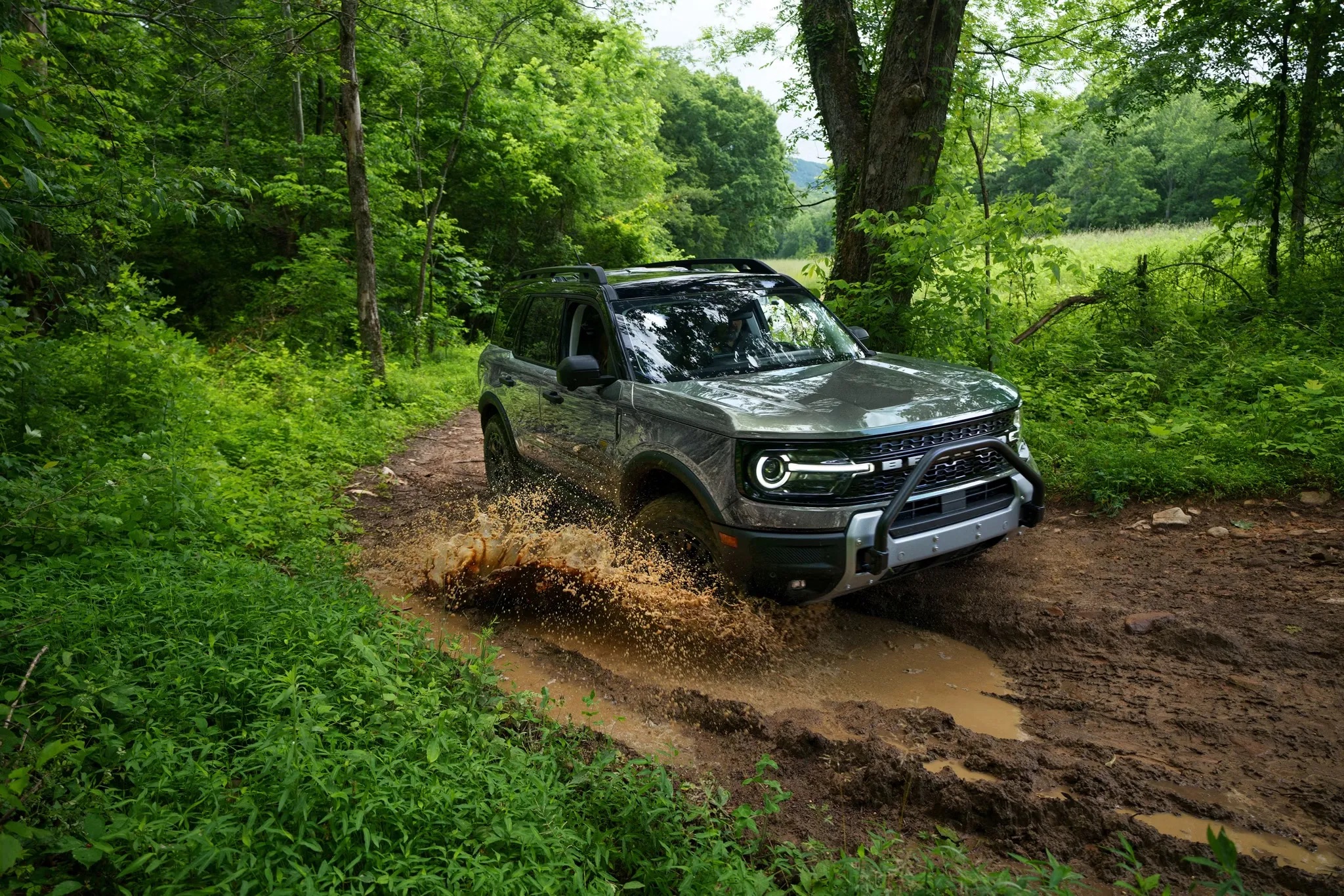 2026 Ford Bronco Sport driving through a wooded trail