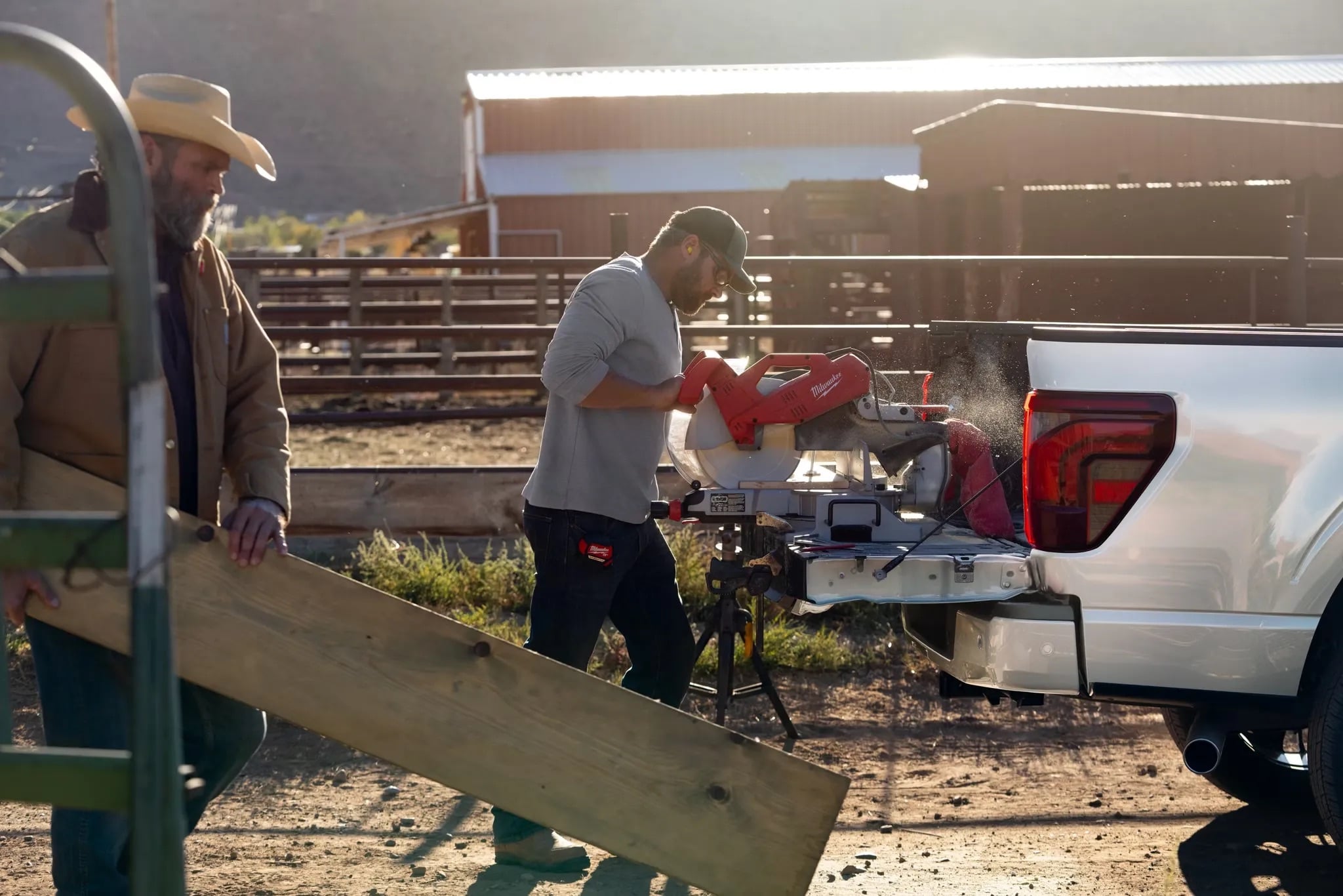 People unloading equipment from the bed of a 2026 Ford F-150