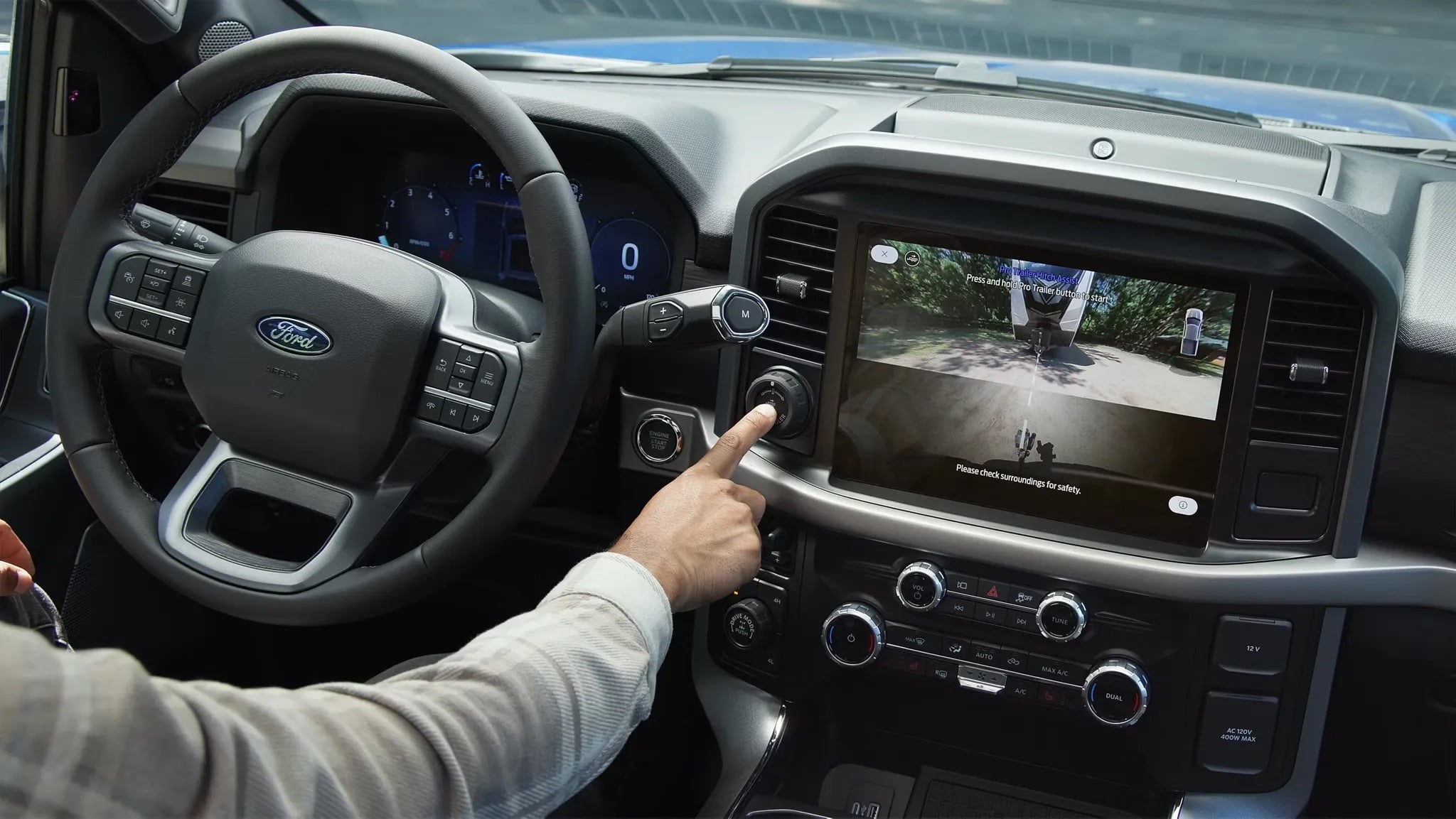 Driver operating infotainment controls inside a 2026 Ford F-150
