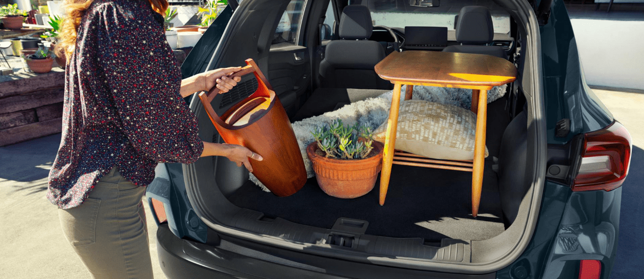 Open trunk of a Ford Escape showing storage space with decor items.