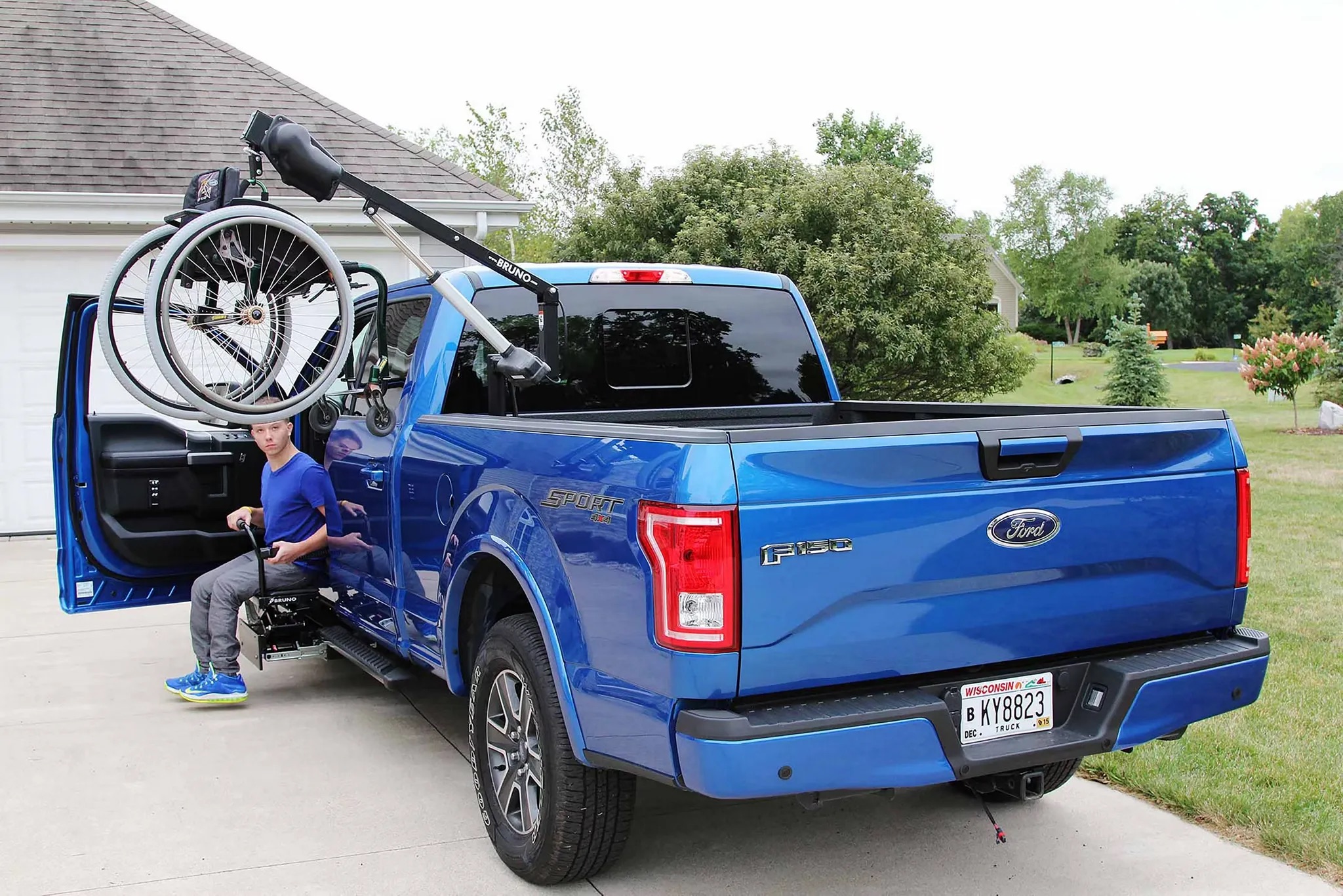 Blue 2026 Ford F-150 parked with equipment loaded in the bed