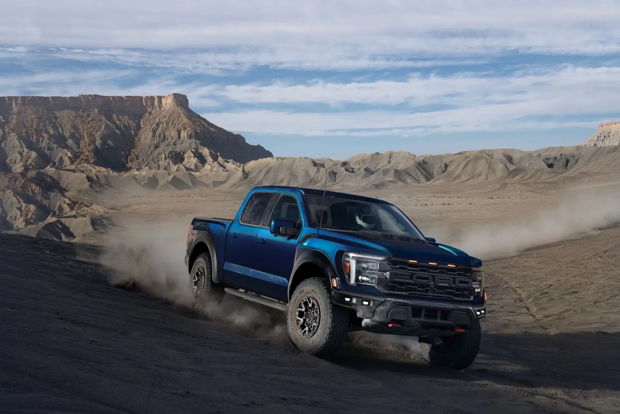 Blue 2026 Ford F-150 driving through a desert landscape