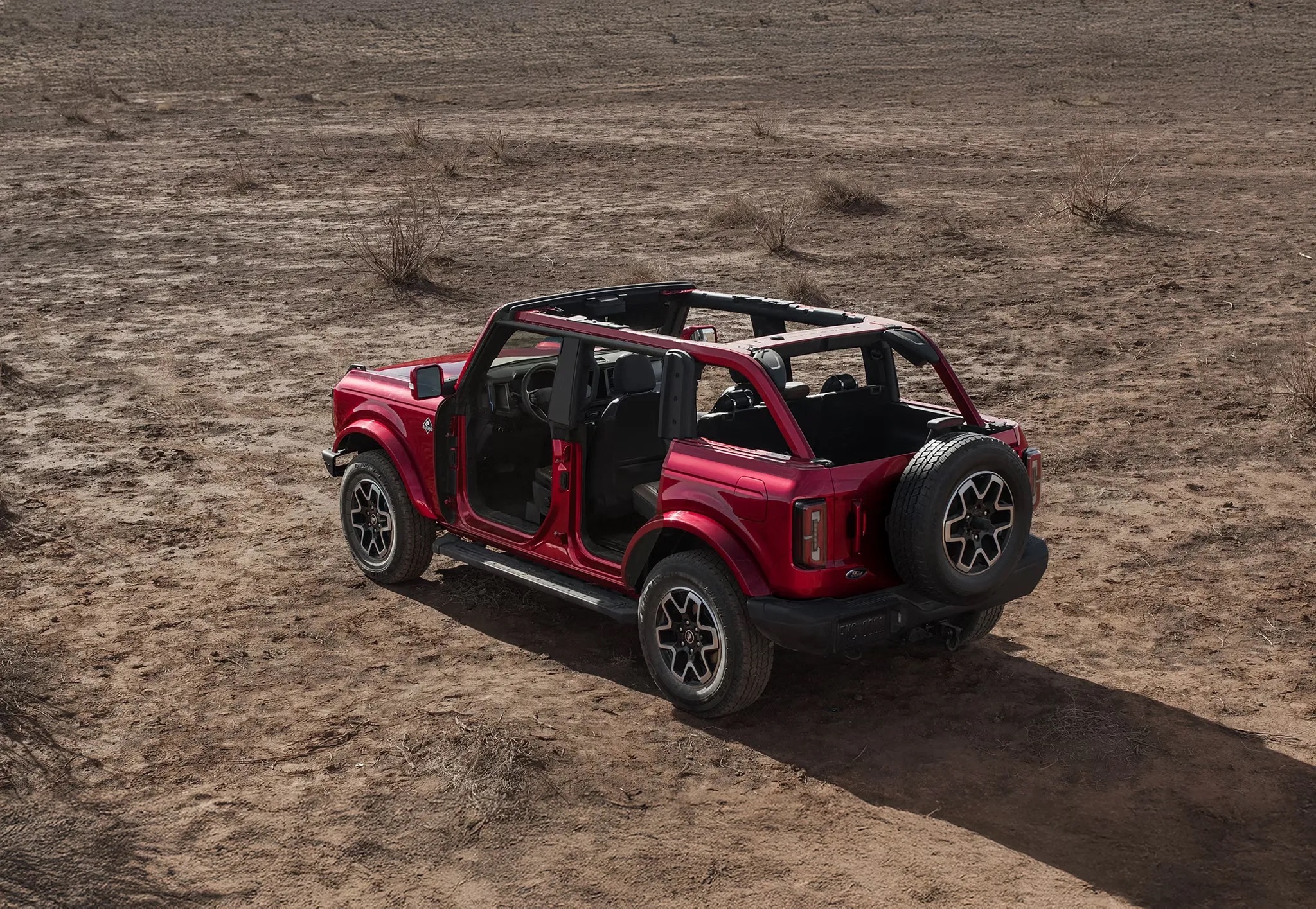 2026 Ford Bronco red open top driving on desert terrain