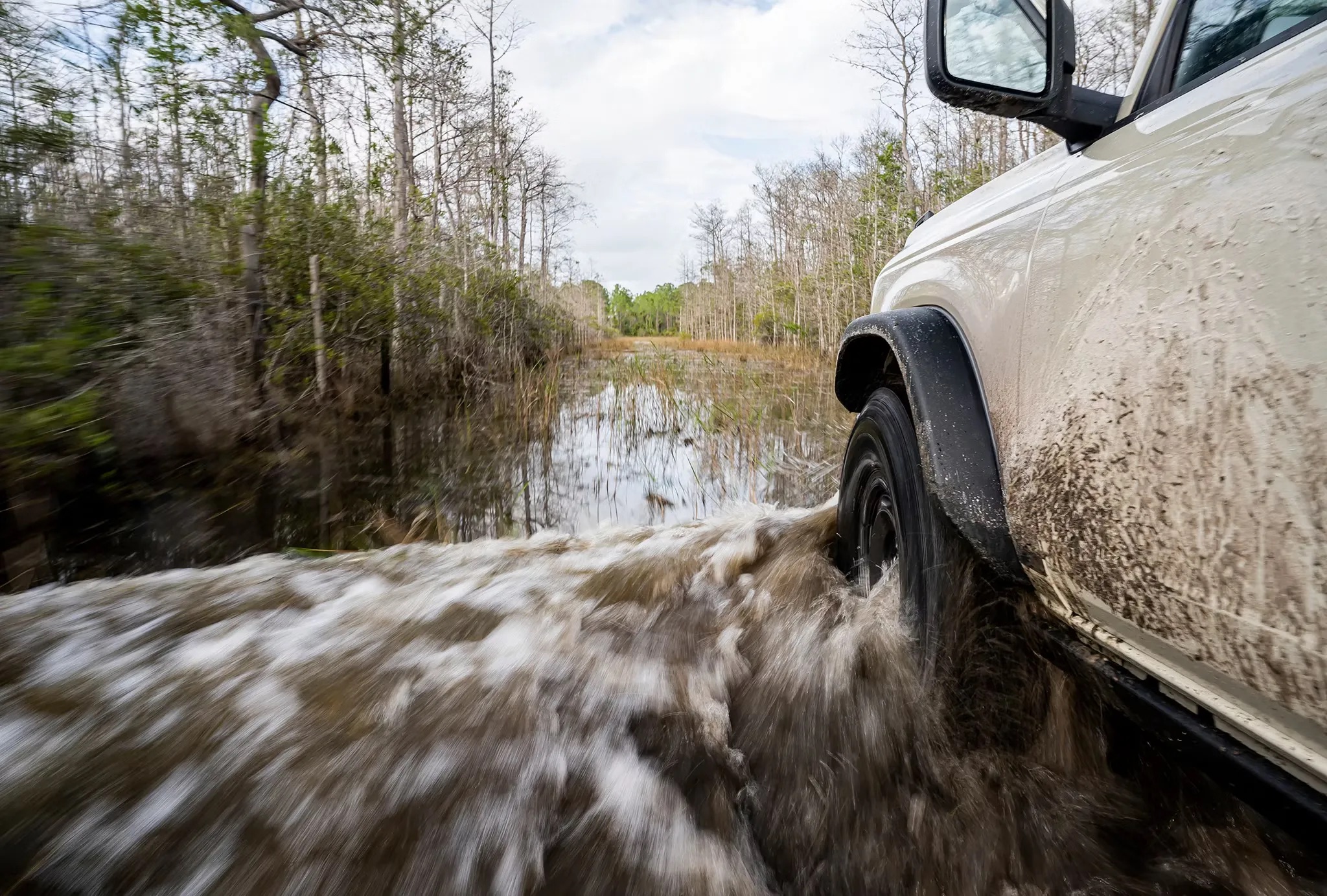 2026 Ford Bronco driving through muddy water off road capability