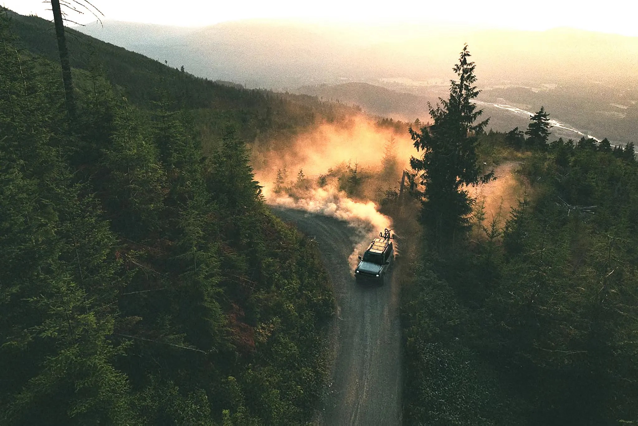 2026 Ford Bronco driving through forest trail aerial view