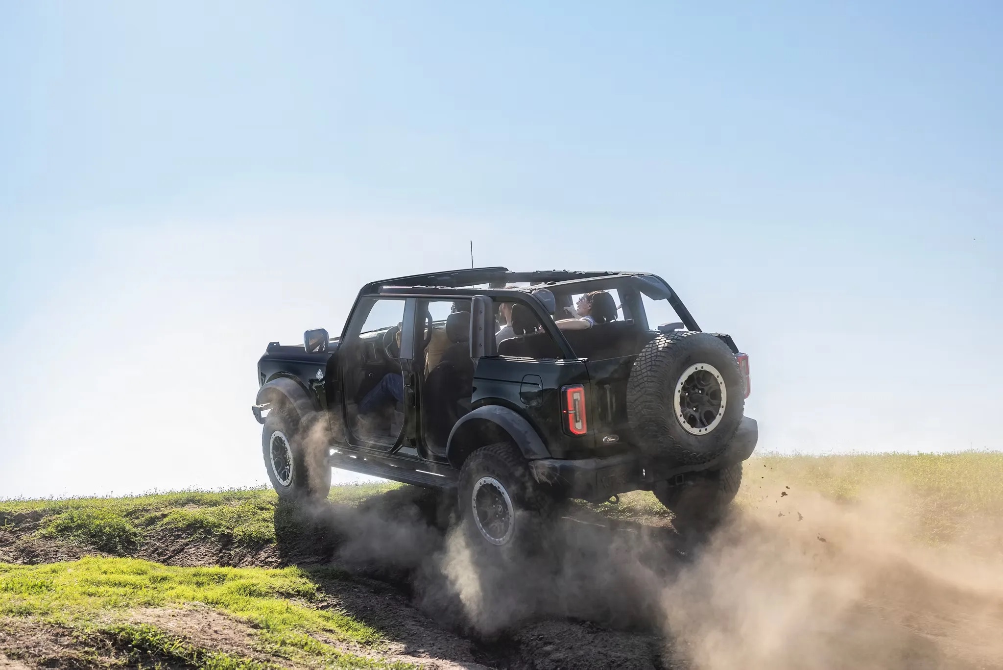 2026 Ford Bronco rear view driving off road trail