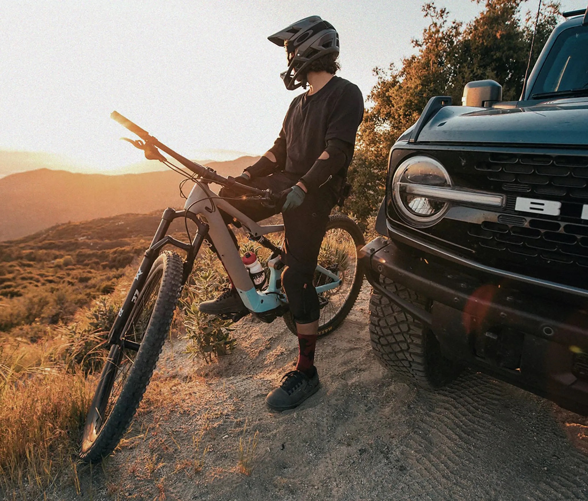 2026 Ford Bronco driver unloading bike from rear cargo lifestyle shot