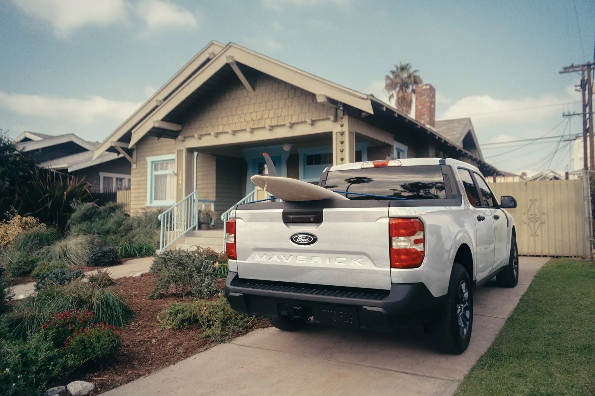 2026 Ford Maverick rear view parked outside home showing truck bed