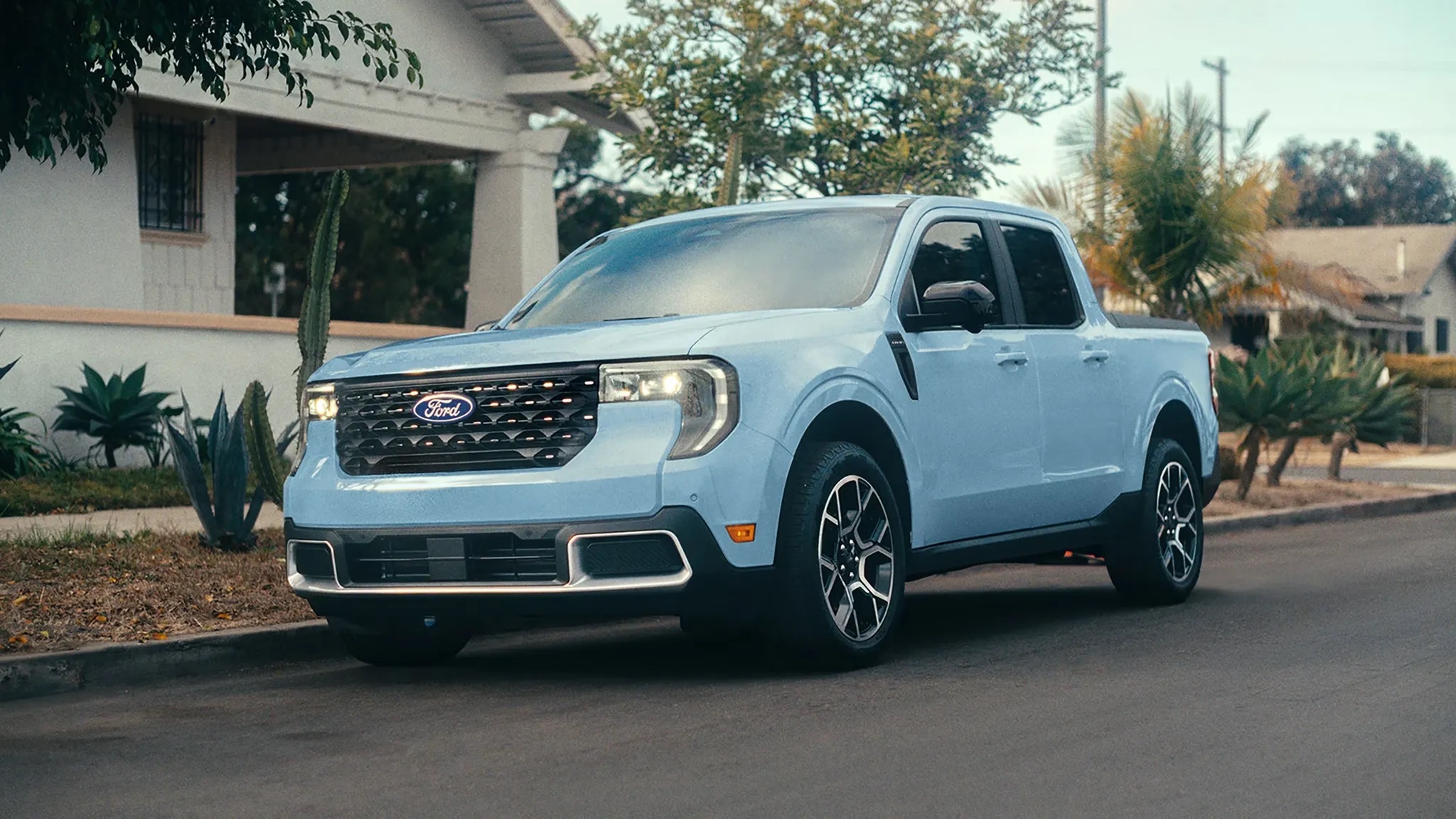 2026 Ford Maverick compact pickup parked in residential driveway exterior view