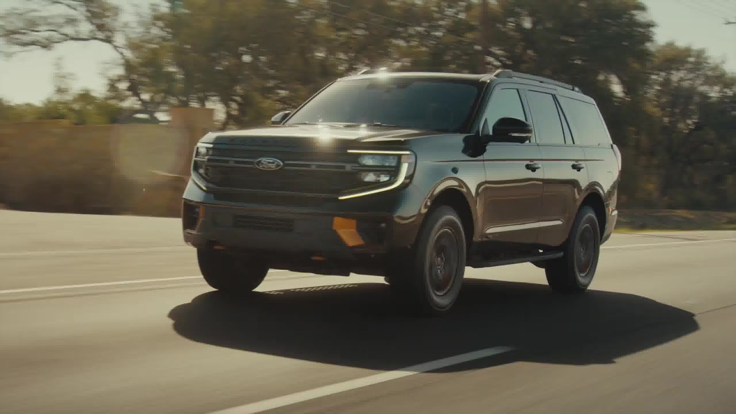 2026 Ford Expedition driving on paved road front three quarter view