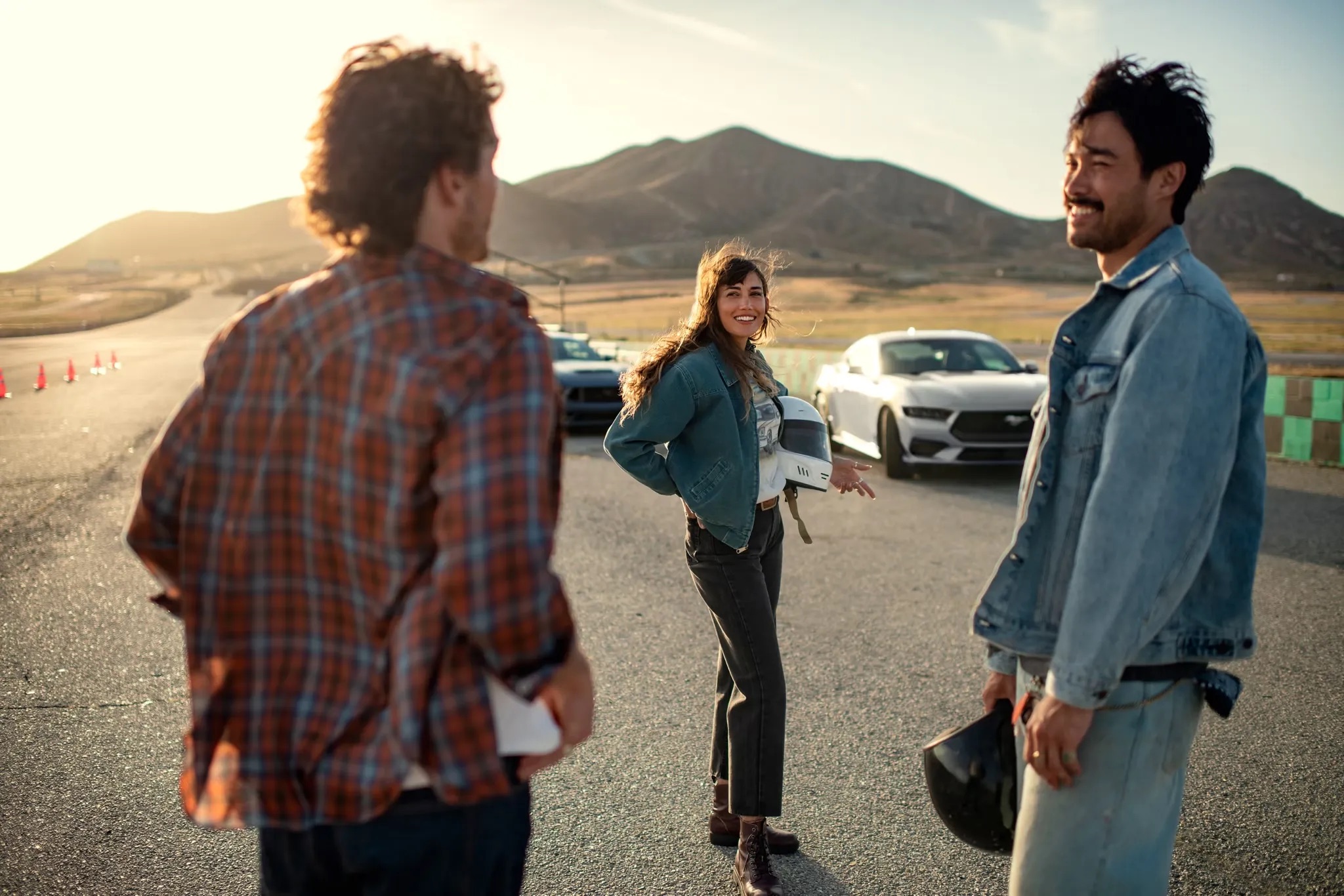 2026 Ford Mustang lifestyle shot with drivers standing beside vehicle outdoors