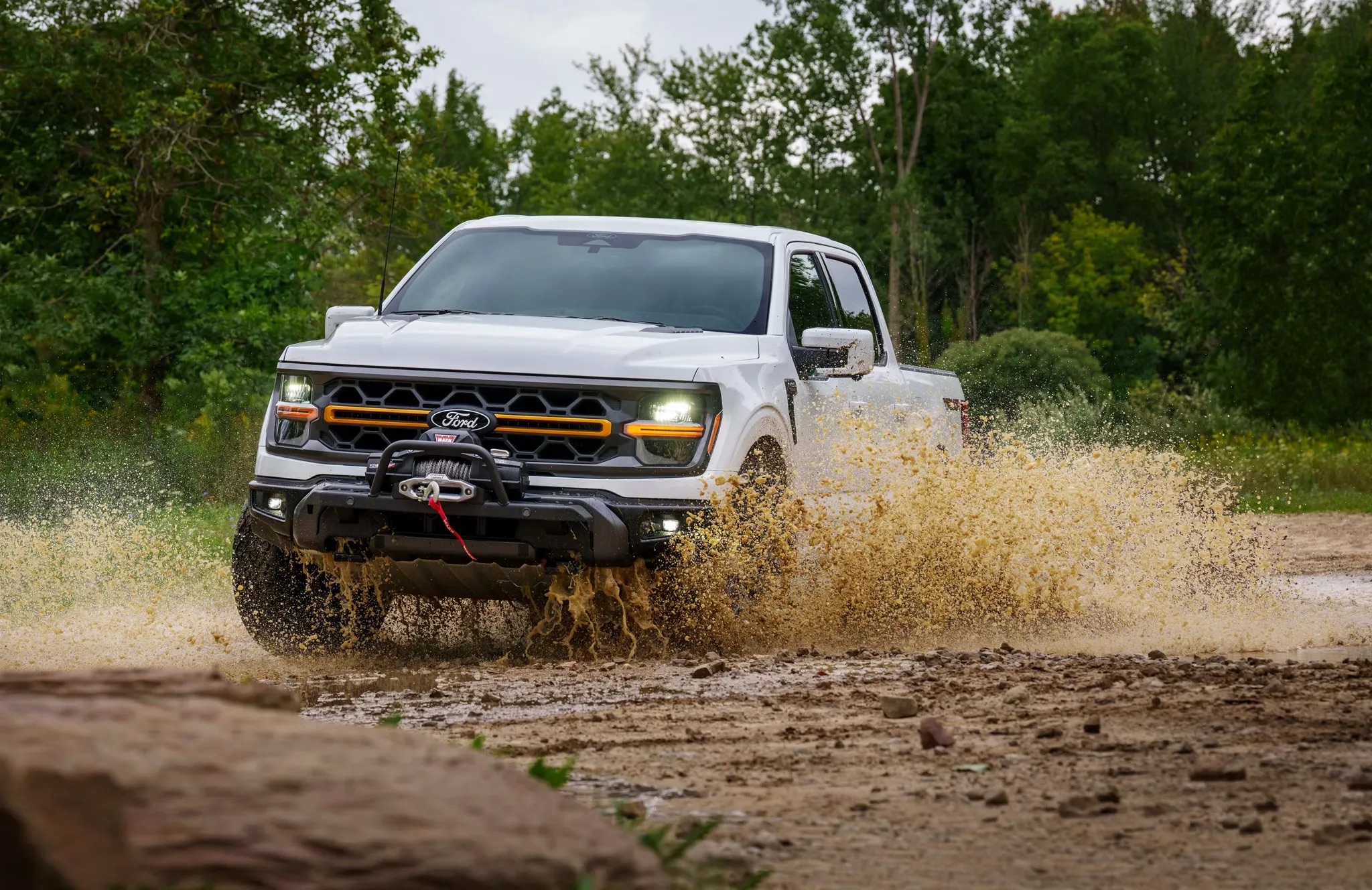 Pickup truck splashing through mud