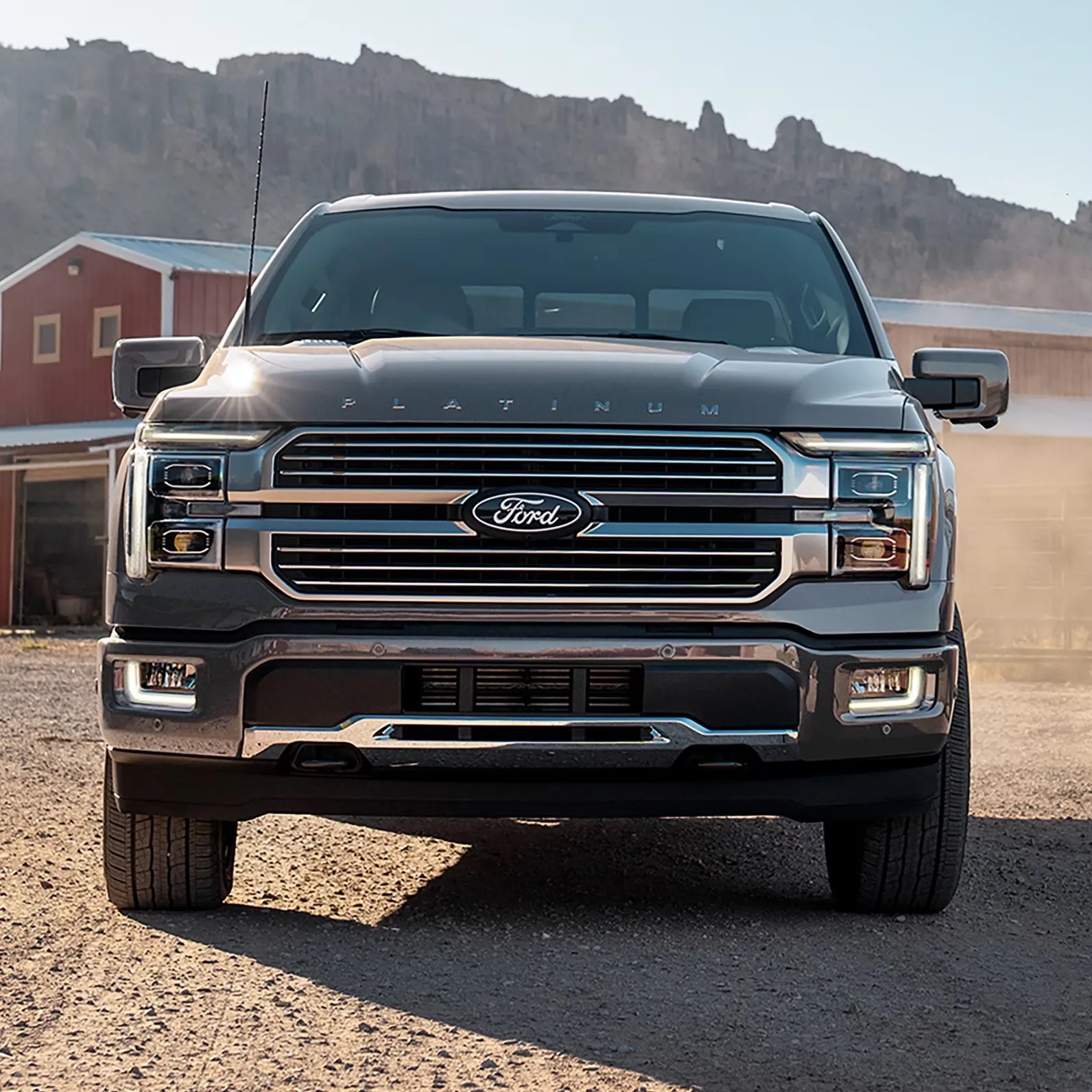 Front view of a pickup truck driving on a rugged road