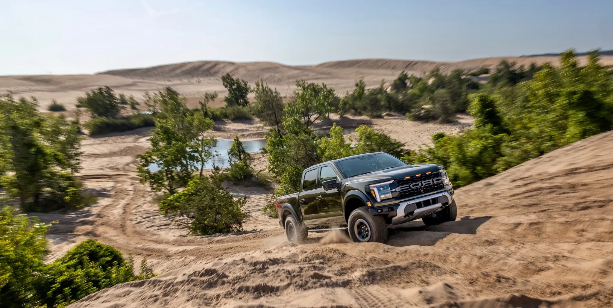 Pickup truck parked on a trail in a desert landscape