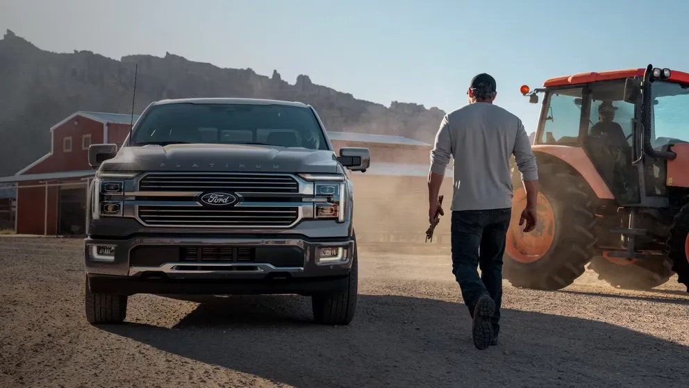 Pickup truck parked outdoors with two people walking nearby