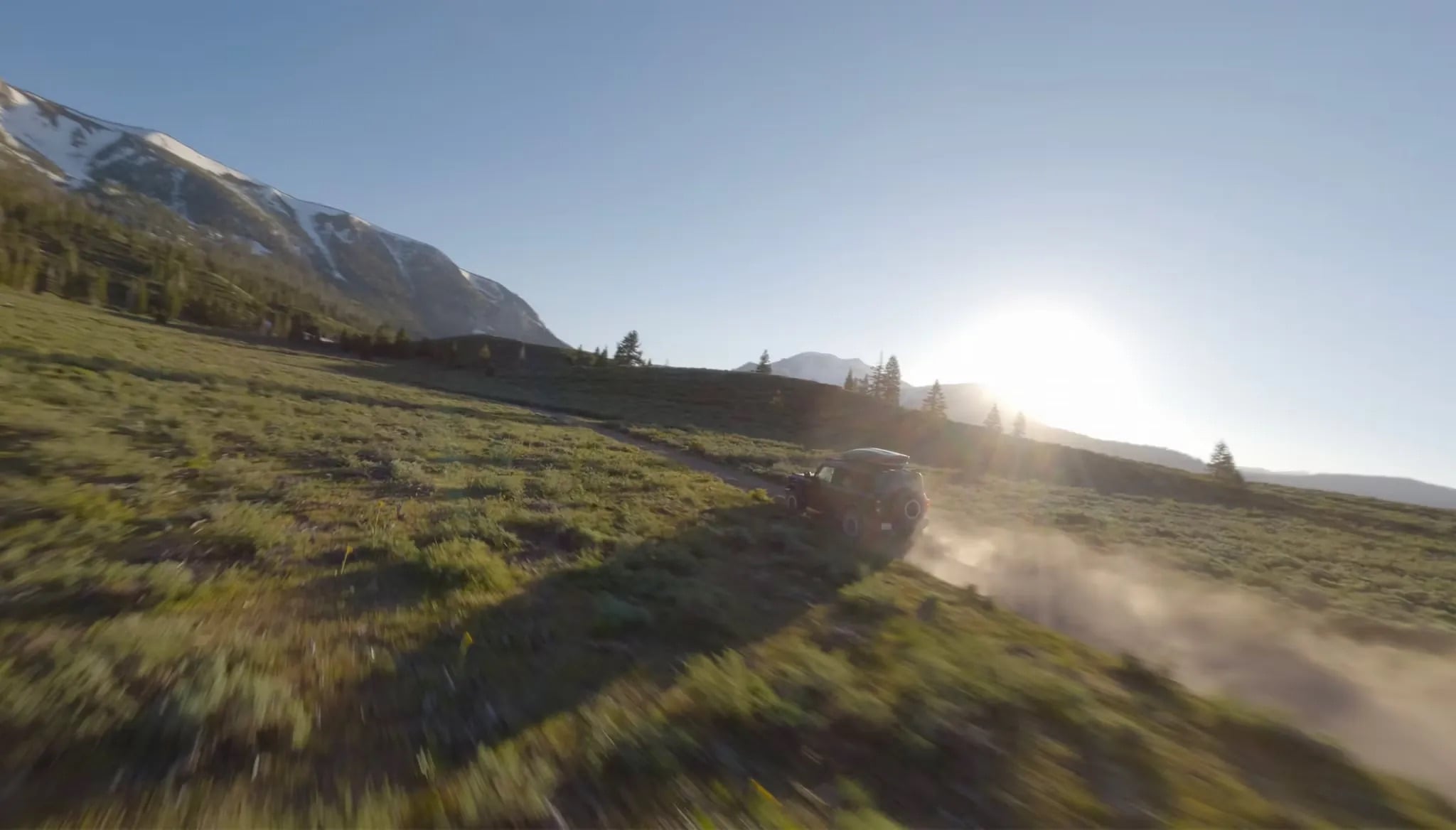 2026 Ford Bronco driving through scenic mountain road landscape