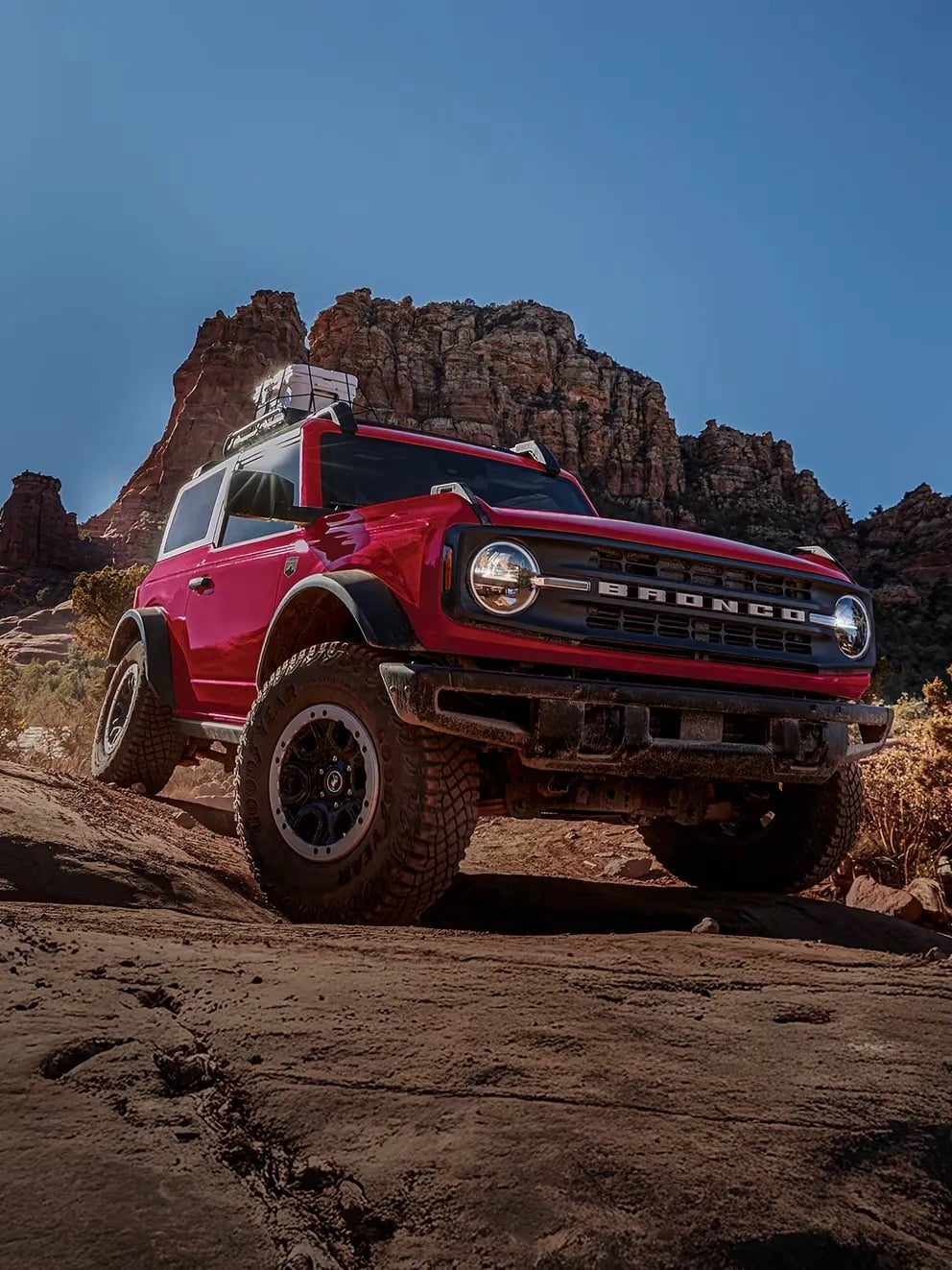 2026 Ford Bronco red off road SUV climbing rocky terrain trail