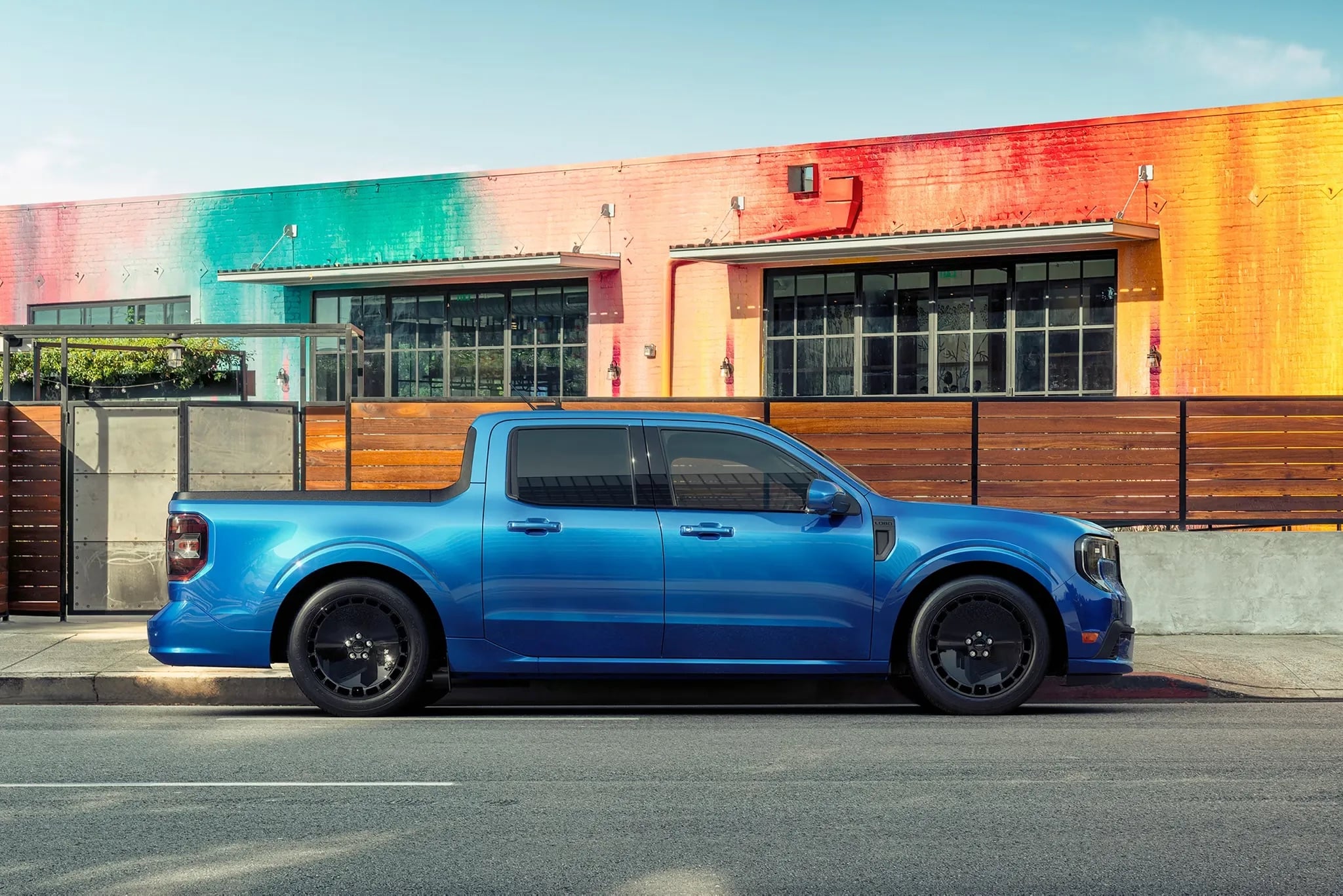 2026 Ford Maverick blue compact pickup parked in urban setting side view