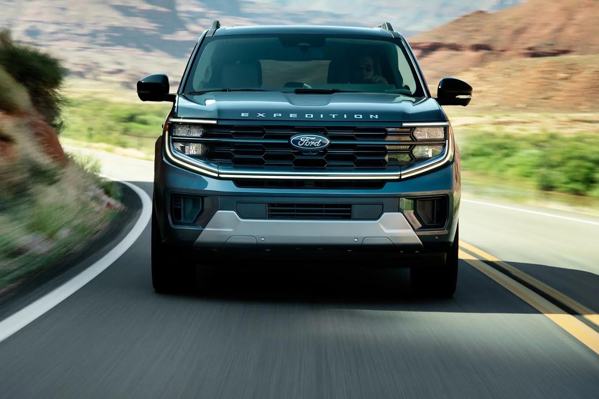 2026 Ford Expedition driving on open road front angle view