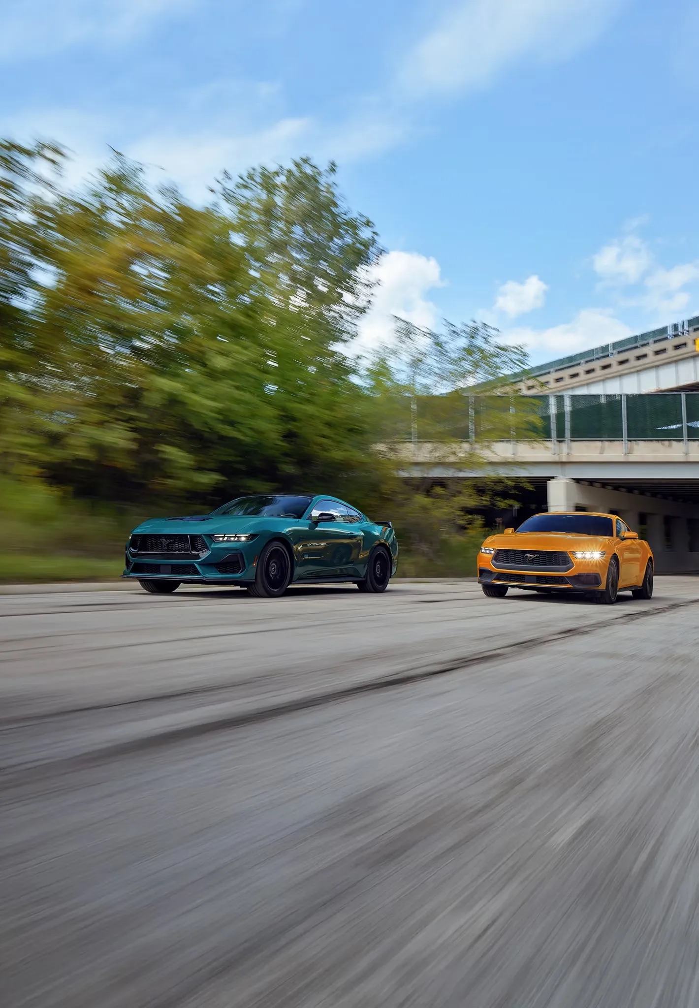 2026 Ford Mustang driving alongside another Mustang performance cars on road