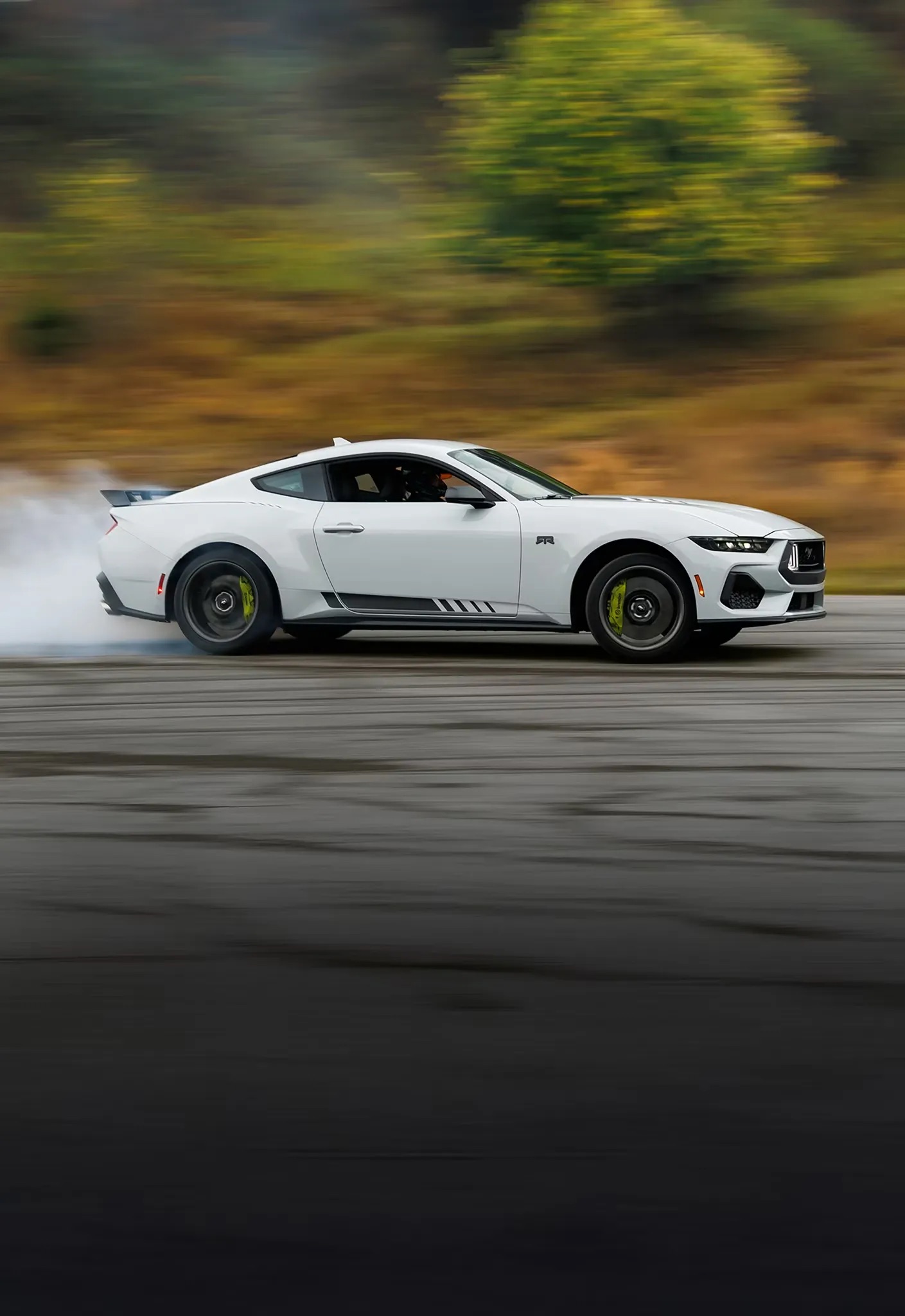 2026 Ford Mustang white sports car driving on road side profile