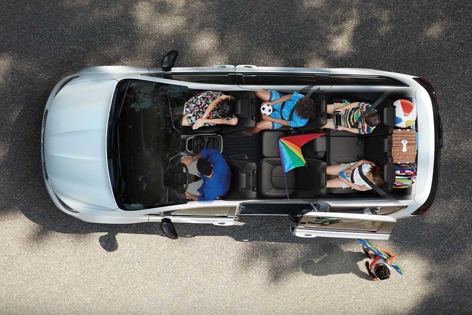 Top-down view of the 2026 Chrysler Pacifica interior filled with passengers and gear, showcasing spacious three-row seating.